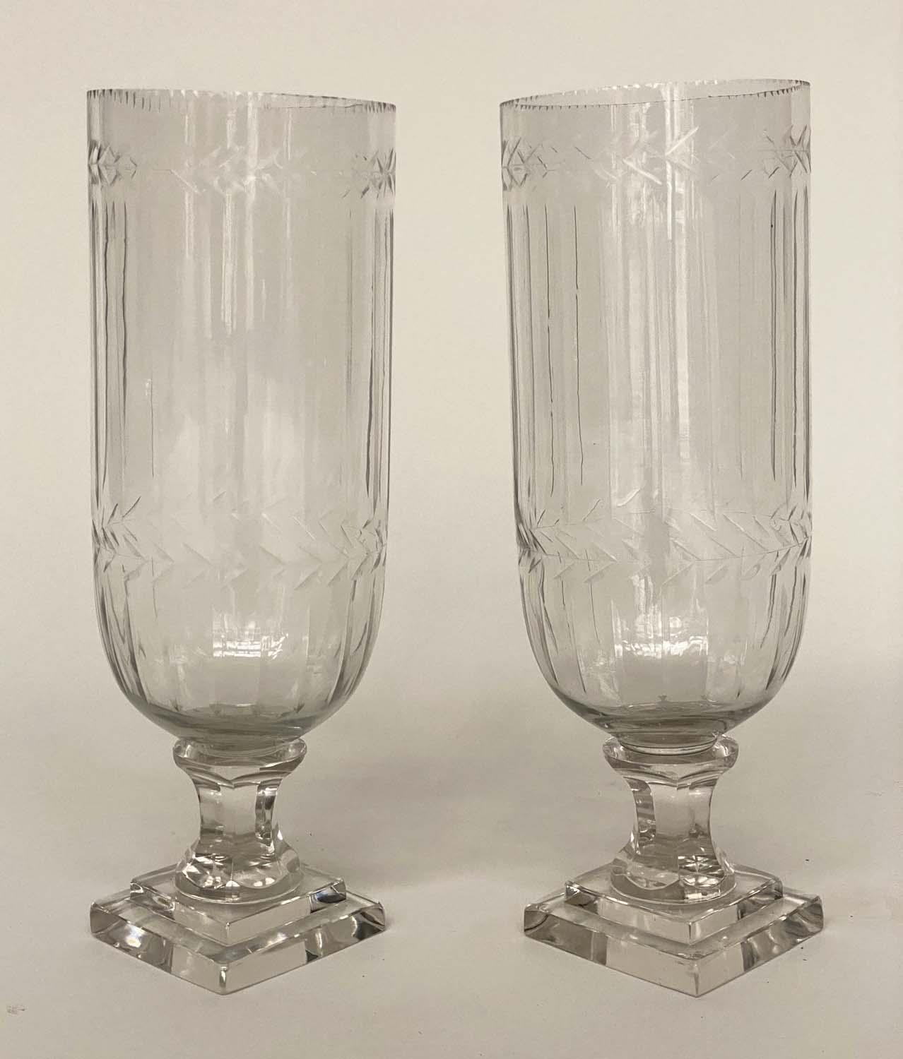 STORM LANTERNS, a pair, cut glass and engraved with facetted stepped plinth, 34cm H. (2)