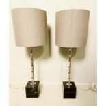 TABLE LAMPS, pair, 76cm H, faux bamboo design columns, raised on black marble bases, grey shades.
