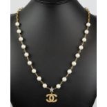 CHANEL PEARL NECKLACE, with star and CC logo, along with a pair of pearl earrings and a pair of star