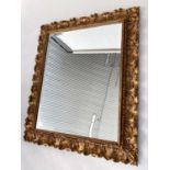 WALL MIRROR, Italian carved giltwood rectangular with bevelled plate and foliate carved frame by '