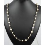 CHANEL LONG FAUX PEARL CC NECKLACE with a pair of CC earrings and heart dangle earrings. (3)