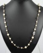 CHANEL LONG FAUX PEARL CC NECKLACE with a pair of CC earrings and heart dangle earrings. (3)