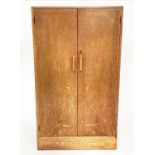 WARDROBE, 1950s oak in the manner of Heals of London with two doors enclosing hanging space and