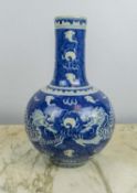A CHINESE BLUE AND WHITE PORCELAIN BULBOUS VASE, Qing mark to base, decorated with a dragon