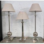 TABLE LAMPS, a pair and one other of differing design, polished metal, with shades, 85cm at tallest.