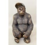 GORILLA WEARING A BASEBALL CAP, 60cm high, 40cm wide, 34cm deep, faux bronze.