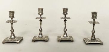 CANDLESTICKS, a set of four, silvered, probably early 20th century with column and square bases,