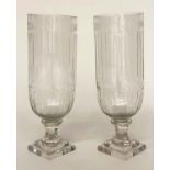 STORM LANTERNS, a pair, cut glass and engraved, cylindrical with facetted stepped plinths, 34cm