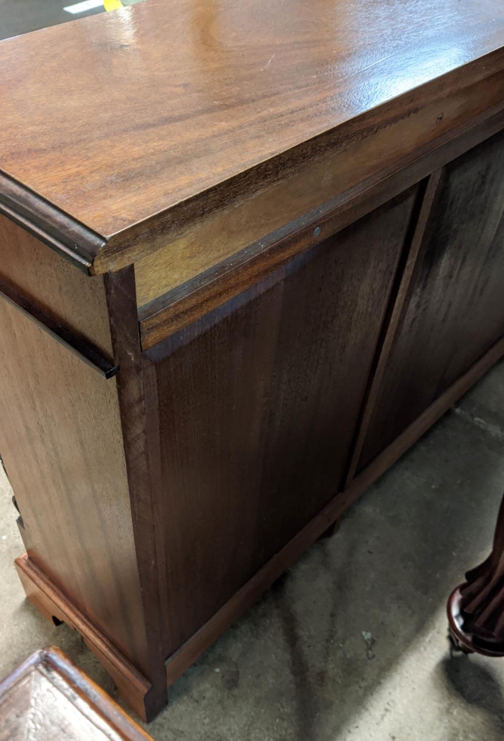 LOW BREAKFRONT BOOKCASE, 33cm D x 76cm H x 155cm W, late 20th century Victorian style mahogany