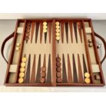 BACKGAMMON SET, in a leathered case 7cm x 40cm x 23cm.