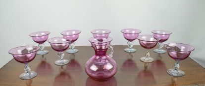 CRANBERRY GLASSES, a set of ten, with spiral twist stems and matching jug. (11)