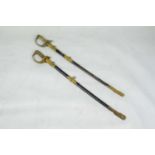 THAI NAVY OFFICERS ELEPHANT HEAD DRESS SWORDS, two, in black leather scabbards with brass mounts. (