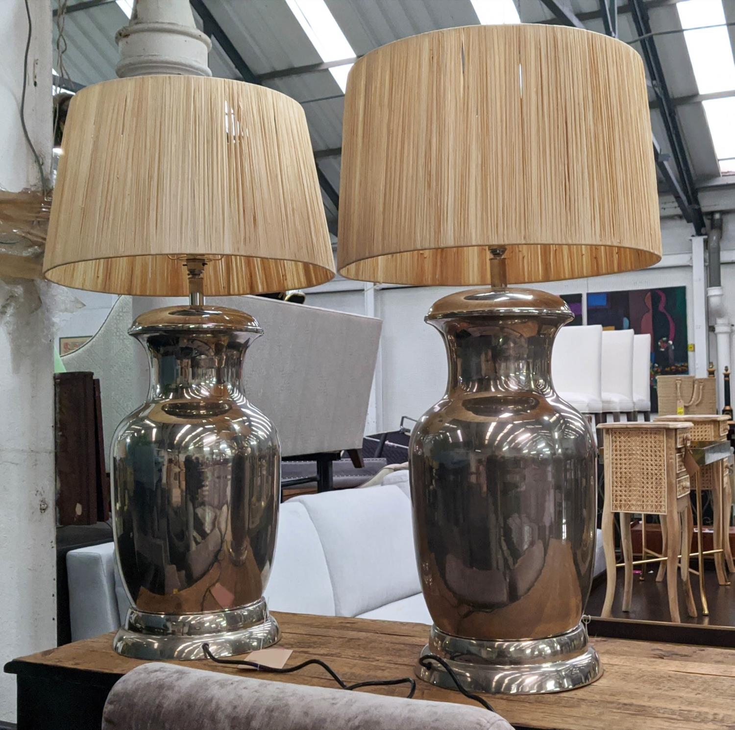 TABLE LAMPS, a pair, polished metal urn design, with shades, 91cm H. (2)