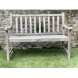 GARDEN BENCH, weathered teak of slatted form, 122cm W.