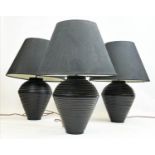 TABLE LAMPS, a set of three, black ceramic ribbed design with shades, 75cm H. (3)