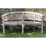 BANANA GARDEN BENCH, weathered teak and slatted of arched form, 160cm W.