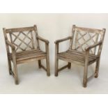 GARDEN ARMCHAIRS BY ALEXANDER ROSE, a pair, weathered teak each slatted construction with lattice