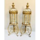 STORM LANTERNS ON STANDS, 115cm high, 34cm diameter, Regency style, gilt metal frames. (2)