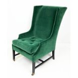 WING ARMCHAIR, moss green mohair velvet upholstered with ebonised base and brass front castors,