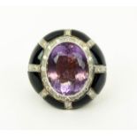 AN 18CT GOLD AMETHYST SET DRESS RING, with a black onyx and diamond encrusted surround, ring size '