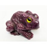 A RUBY CARVED TOAD, glass eyes, initialled 'H.W.', 4cm long, 72 grams.