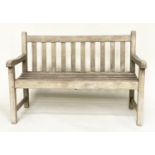 GLOSTER GARDEN BENCH, weathered teak of slatted and dowelled construction, 122cm W.