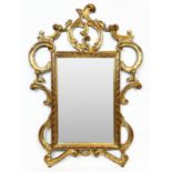 WALL MIRROR, early 20th century Italian giltwood scrolling frame with a rectangular plate, 116cm x