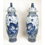 LIDDED TEMPLE VASES, a pair, Chinese blue and white decorated with mythical lions, dragons bats