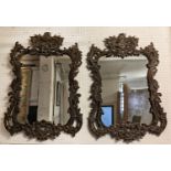 WALL MIRRORS, a pair, Rococo style, ebonised wood finish with scrolled acanthus leaf frames, 117cm H