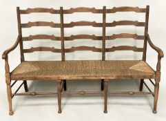 HALL SEAT, early 20th century English oak with raised ladder back and rush seat, 157cm W.