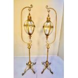 STORM LANTERNS ON STANDS, a pair, 163cm H x 35cm diam, Regency style, gilt metal. (2)