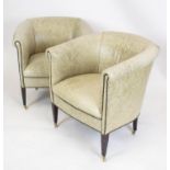 TUB CHAIRS, 76cm H x 76cm, a pair, stone grey leather on brass castors. (2)