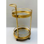 COCKTAIL TROLLEY, 77cm H x 42cm diam, 1960's French style, gilt metal and mirror.