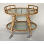 CANE TROLLEY/TABLE, 1950s style rattan and cane bound, two tier and glazed.
