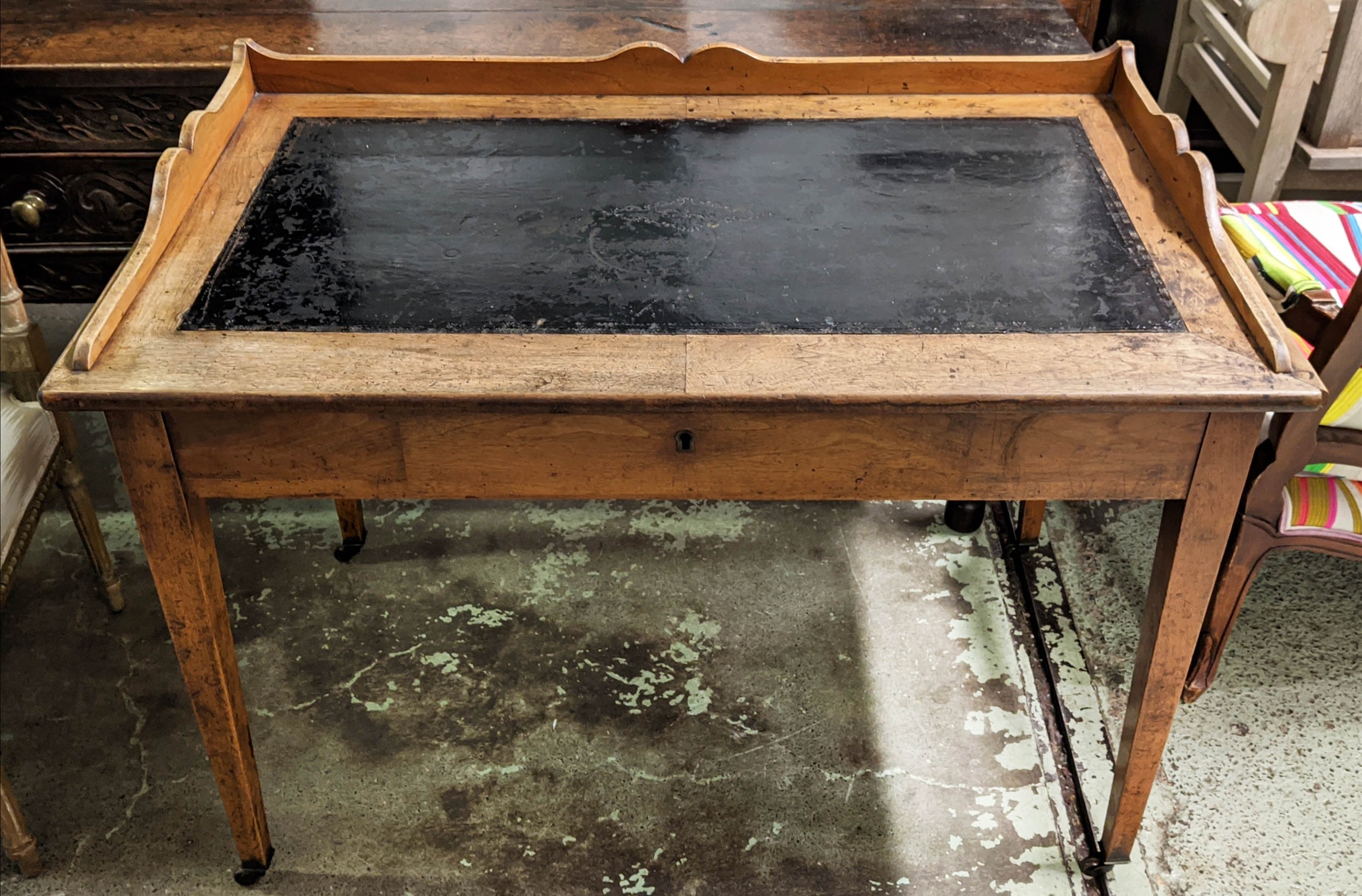 WRITING TABLE, 111cm W x 64cm D x 85cm H, 19th century French walnut with a shaped gallery and black