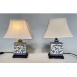 TABLE LAMPS, a pair, Chinese ceramic square form, imperial yellow ground, inset panels with shades