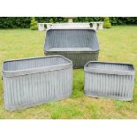 TRONGLE PLANTERS, a graduated set of three, galvanised, 33cm x 60cm x 38cm at largest.