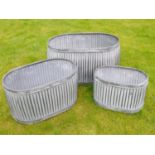 GARDEN PLANTERS, graduated set of three, largest measuring 35cm H x 64cm x 40cm, galvanised