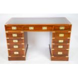 CAMPAIGN STYLE PEDESTAL DESK, 77cm H x 121cm x 58cm D, yewwood and brass bound with leather top