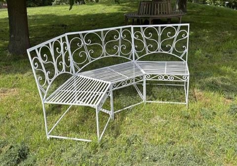 GARDEN BENCH, white painted wrought iron corner or bowed with scroll back and rail seat (in three