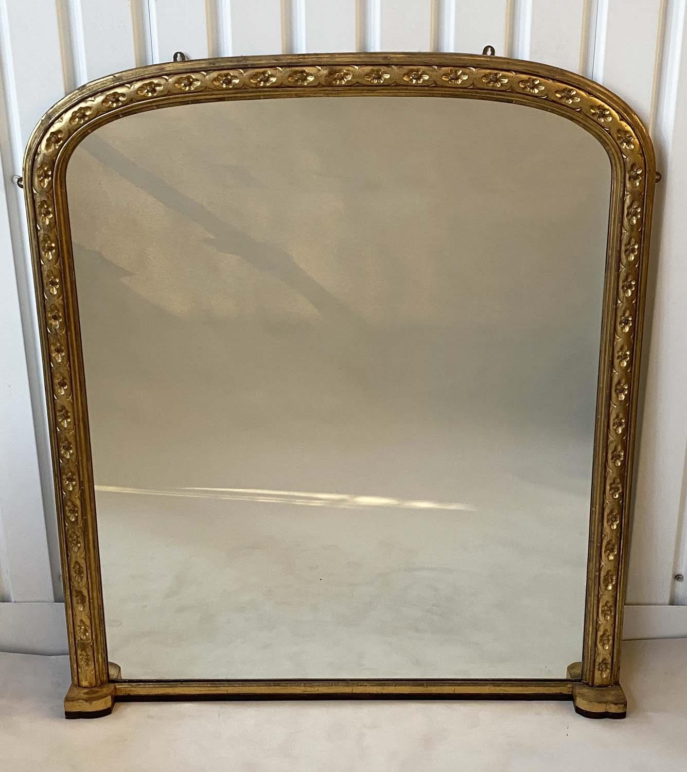 OVERMANTEL MIRROR, late 19th century English carved giltwood with arched moulded frame and