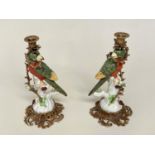 PARROT CANDLESTICKS, a pair, Continental style decorated porcelain and gilt metal mounted, 36cm