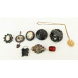 A COLLECTION OF ASSORTED MOURNING JEWELLERY, comprising four Whitby Jet brooches, a 19th Century