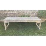LOW TABLE, rectangular weathered teak and slatted with stretchered supports, 149cm x 43cm x 42cm H.