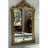 OVERMANTEL MIRROR, 19th century French giltwood and gesso moulded with arched C scroll crest, beaded