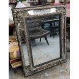 WALL MIRROR, 19th century Flemish silvered repoussé brass frame, with marginal mirrored bevelled