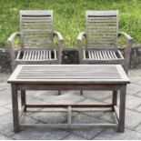 GARDEN ARMCHAIRS, a pair, stacking weathered teak finely slatted together with a matching low table,