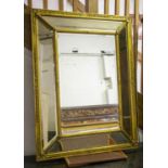 WALL MIRROR, 117cm x 88cm, late 19th century giltwood and gesso with cushion frame.