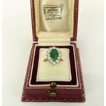 AN EMERALD AND DIAMOND DRESS RING, the pear cut emerald of approximately 1.5ct, surrounded by twelve