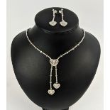 AN 18CT WHITE GOLD DIAMOND SET PENDANT NECKLACE AND EARRING SET, the pendants in the form of hearts,